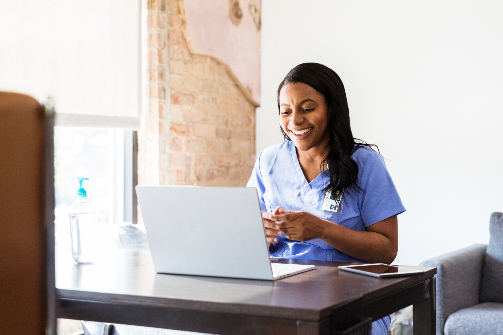 Happy doctor talks with patient during telemedicine appointment
